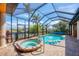 Heated pool and hot tub under a screened enclosure with canal view at 15092 Chinook Way, Port Charlotte, FL 33981