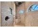 Luxurious walk-in shower with tiled walls, rain shower head, mosaic ceiling and window at 15092 Chinook Way, Port Charlotte, FL 33981