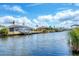 Waterfront view of homes with docks, boats, and lush green landscaping at 15092 Chinook Way, Port Charlotte, FL 33981