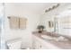 A clean bathroom featuring a granite countertop, a large mirror and tiled shower at 1531 Placida Rd # 4-103, Englewood, FL 34223