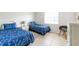 Bedroom with two twin beds, side table, and window bringing in lots of natural light at 1531 Placida Rd # 4-103, Englewood, FL 34223