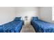 Bright bedroom featuring twin beds with matching comforters and white accents at 1531 Placida Rd # 4-103, Englewood, FL 34223