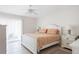 Bright bedroom featuring neutral walls, light tile floors, and access to outdoor patio at 1531 Placida Rd # 4-103, Englewood, FL 34223