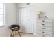 Bedroom with a chest of drawers, accent chair and natural light streaming through the window at 1531 Placida Rd # 4-103, Englewood, FL 34223