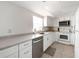Bright kitchen features white cabinetry, stainless steel dishwasher, and complementing countertops at 1531 Placida Rd # 4-103, Englewood, FL 34223