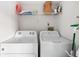 Functional laundry room with a side by side washer and dryer at 1531 Placida Rd # 4-103, Englewood, FL 34223