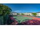 Well-kept tennis court with surrounding trees and nearby parking at 1531 Placida Rd # 4-103, Englewood, FL 34223