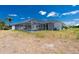 Spacious backyard featuring a screened-in pool, lush landscaping, and plenty of room for outdoor activities at 162 Fairway Rd, Rotonda West, FL 33947