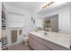 Bathroom featuring a vanity, large mirror, neutral tiling, and decorative seahorse accents at 162 Fairway Rd, Rotonda West, FL 33947