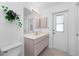 Bright bathroom featuring a spacious vanity, ample storage, and a convenient door to the outside at 162 Fairway Rd, Rotonda West, FL 33947
