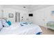 Comfortable bedroom with a king-size bed, complemented by a TV, ensuite bathroom, and tranquil decor at 162 Fairway Rd, Rotonda West, FL 33947