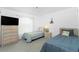 Bright bedroom with twin beds, a ceiling fan, and a large window providing natural light at 162 Fairway Rd, Rotonda West, FL 33947