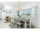 Dining room featuring a wooden table with seating for six and a large window with natural light at 162 Fairway Rd, Rotonda West, FL 33947