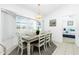 Bright dining room features a modern table with seating for six and ample natural light at 162 Fairway Rd, Rotonda West, FL 33947