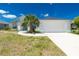 Charming one-story home featuring a white exterior with a well-manicured lawn and a two-car garage at 162 Fairway Rd, Rotonda West, FL 33947