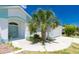 Charming home featuring light blue accents, a well-maintained lawn, and a convenient two-car garage at 162 Fairway Rd, Rotonda West, FL 33947