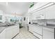 Bright kitchen with white cabinets, modern appliances, and lots of natural light at 162 Fairway Rd, Rotonda West, FL 33947