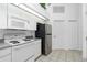 Bright kitchen with modern appliances and tile flooring at 162 Fairway Rd, Rotonda West, FL 33947