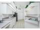 Modern kitchen with white cabinets, stainless steel appliances, and tile flooring at 162 Fairway Rd, Rotonda West, FL 33947