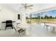 Covered lanai with multiple seating areas, a grill, and view of the pool at 162 Fairway Rd, Rotonda West, FL 33947