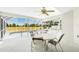 Screened lanai with ample seating, ceiling fan, and view of the refreshing pool at 162 Fairway Rd, Rotonda West, FL 33947