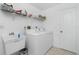 Laundry room featuring a washer, dryer, sink, and shelving for storage at 162 Fairway Rd, Rotonda West, FL 33947