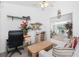 Bright room with a desk, shelving, and a comfortable sofa offering versatile space for relaxation and productivity at 162 Fairway Rd, Rotonda West, FL 33947