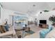 Bright living room features vaulted ceilings, modern furnishings, and sliding glass doors to the pool area at 162 Fairway Rd, Rotonda West, FL 33947