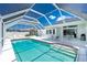 Backyard with screened-in pool, covered patio, and ample seating for outdoor relaxation and entertaining at 162 Fairway Rd, Rotonda West, FL 33947