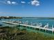 Scenic aerial view of the marina, showcasing boat slips, waterways, and surrounding lush landscape at 16716 Grande Quay Dr, Boca Grande, FL 33921