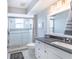 Neat bathroom featuring tile flooring, a glass enclosed shower, and a white vanity at 16716 Grande Quay Dr, Boca Grande, FL 33921