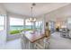 Open dining room featuring large picture windows with waterfront views and tile flooring at 16716 Grande Quay Dr, Boca Grande, FL 33921