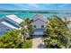 Beautiful waterfront home with lush landscaping and stunning views of the ocean and nearby islands at 16716 Grande Quay Dr, Boca Grande, FL 33921
