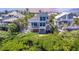 Charming coastal home with spacious balconies, outdoor dining area, and lush tropical landscaping at 16716 Grande Quay Dr, Boca Grande, FL 33921
