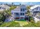 Elegant coastal home with spacious balconies, outdoor dining area, and lush tropical landscaping at 16716 Grande Quay Dr, Boca Grande, FL 33921