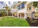 Beautiful two-story home showcasing a covered patio, balcony, and lush landscaping at 16716 Grande Quay Dr, Boca Grande, FL 33921