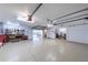 Spacious garage with epoxy flooring and access to the covered patio, perfect for storage and hobbies at 16716 Grande Quay Dr, Boca Grande, FL 33921