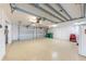 Well-lit, oversized garage featuring ample storage space, multiple doors, and spotless epoxy flooring at 16716 Grande Quay Dr, Boca Grande, FL 33921