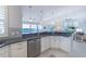 Open kitchen with stainless steel appliances, granite countertops, white cabinets, and waterway views at 16716 Grande Quay Dr, Boca Grande, FL 33921