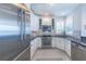 Modern kitchen with stainless steel appliances, white cabinetry, granite countertops, and tile backsplash at 16716 Grande Quay Dr, Boca Grande, FL 33921