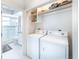 Convenient laundry area with washer, dryer, and storage shelves at 16716 Grande Quay Dr, Boca Grande, FL 33921