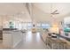 Open-concept living room featuring tile floors, lots of light, modern ceiling fan and beautiful waterfront views at 16716 Grande Quay Dr, Boca Grande, FL 33921