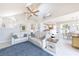Open living room and kitchen with tile floors, ceiling fan and stairway to the second floor at 16716 Grande Quay Dr, Boca Grande, FL 33921