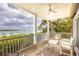 Outdoor porch with ceiling fan, seating and a harbor view at 16716 Grande Quay Dr, Boca Grande, FL 33921