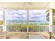 Outdoor porch with seating and a beautiful view of the harbor at 16716 Grande Quay Dr, Boca Grande, FL 33921