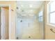 Clean glass enclosed shower featuring white tile and decorative mosaic border at 16716 Grande Quay Dr, Boca Grande, FL 33921