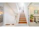 Stairway leading to the second floor with lots of natural light and an office space to the right at 16716 Grande Quay Dr, Boca Grande, FL 33921