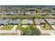 A clear aerial shot of a home on a canal, surrounded by similar properties in a quiet neighborhood at 169 Fairway Rd, Rotonda West, FL 33947