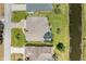 An aerial view of the residence highlighting the screened lanai and pool, with backyard canal access at 169 Fairway Rd, Rotonda West, FL 33947