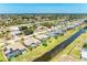 An aerial view of a house with a canal, and a vast neighborhood under clear blue skies at 169 Fairway Rd, Rotonda West, FL 33947